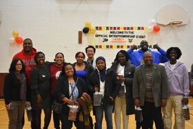 A group of 12 adults smiling together at the end of the event.